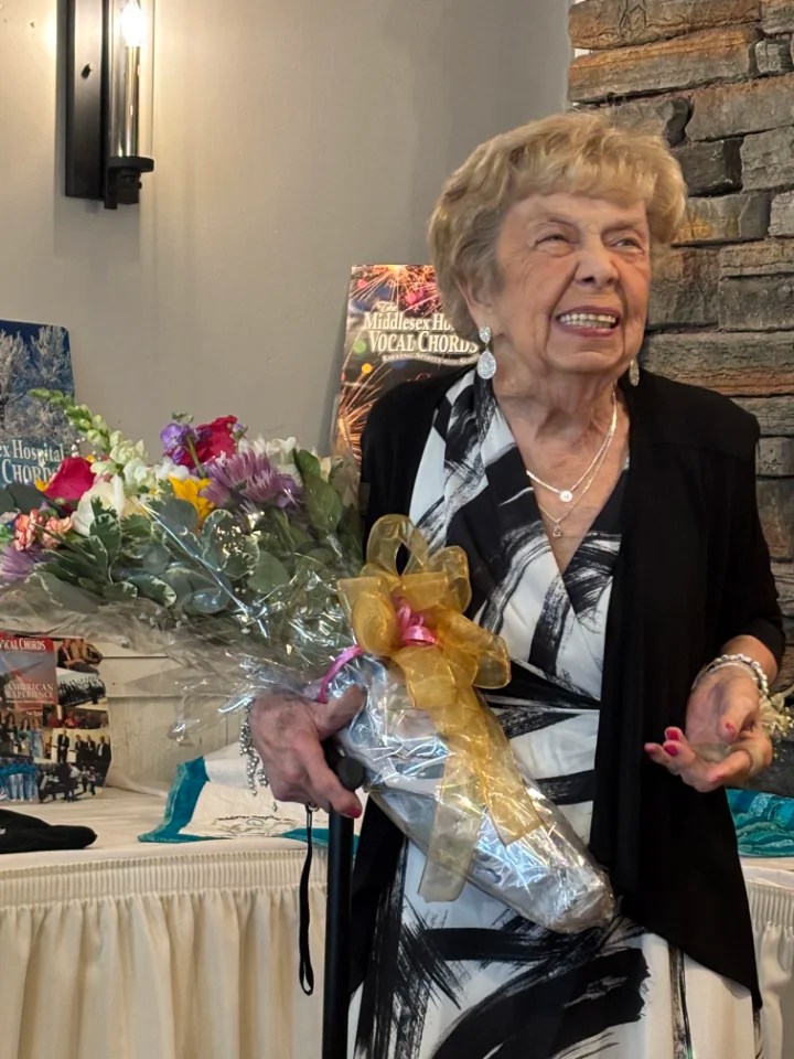 joyce holding a bouquet of flowers